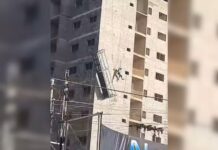Trabalhador fica pendurado em corda após andaime ceder em prédio em construção