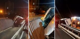 Motorista perde controle e veículo furgão fica pendurado em grade de viaduto